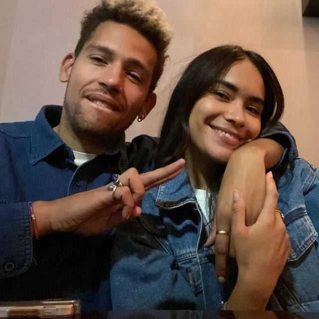 Sulem Calderon in a blue denim jacket posing with her boyfriend in a blue shirt.